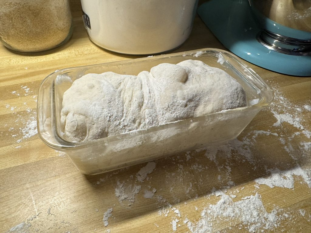 bread dough inside a glass baking dish